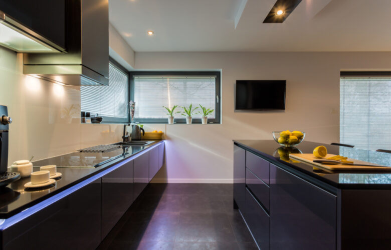 View of dark furniture in white painted kitchen